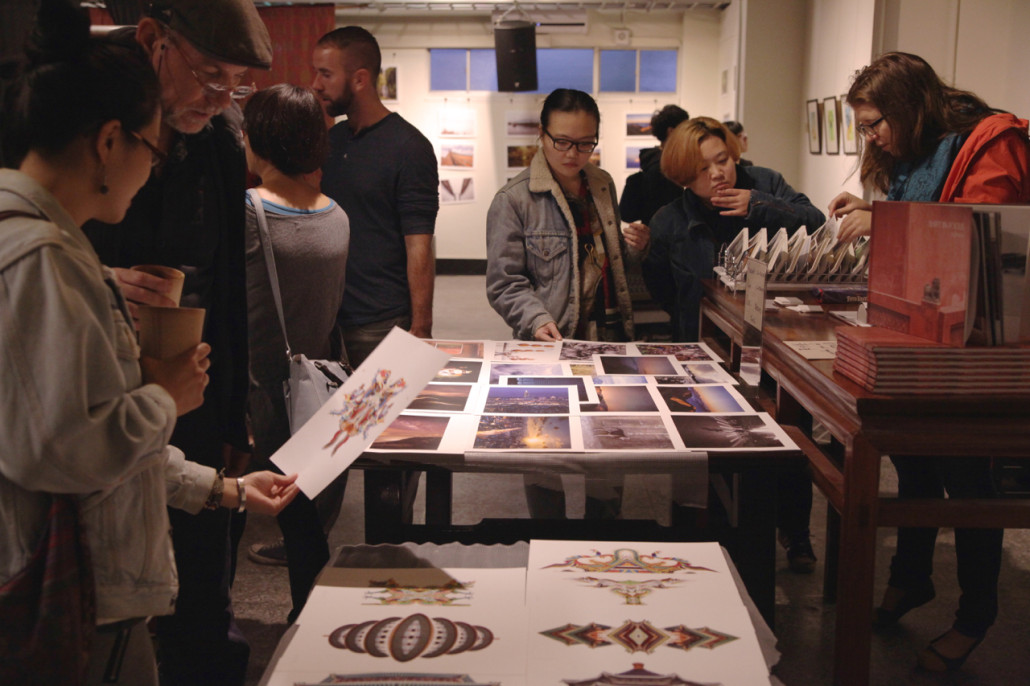 Red Roomers browse through Houghton's prints and peruse his book at the opening of Red Room's third Visual Dialogues